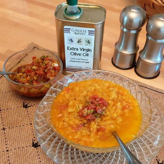 Hogao spooned into chicken lentil soup